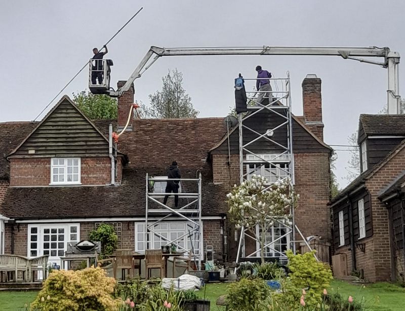 The Moss Cleaners using cherry picker and scaffolding to clean roof safely and professionally in 65 Station Rd, Thames Ditton KT7 0PA, UK, 65 Station Rd, Thames Ditton KT7 0PA, UK